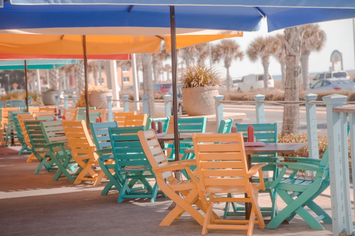 tables and chairs near the water in panama city beach
