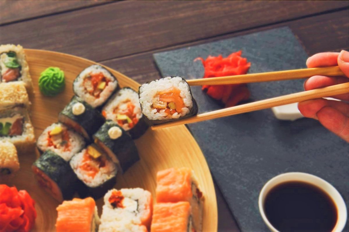 Sushi being eaten with chopsticks